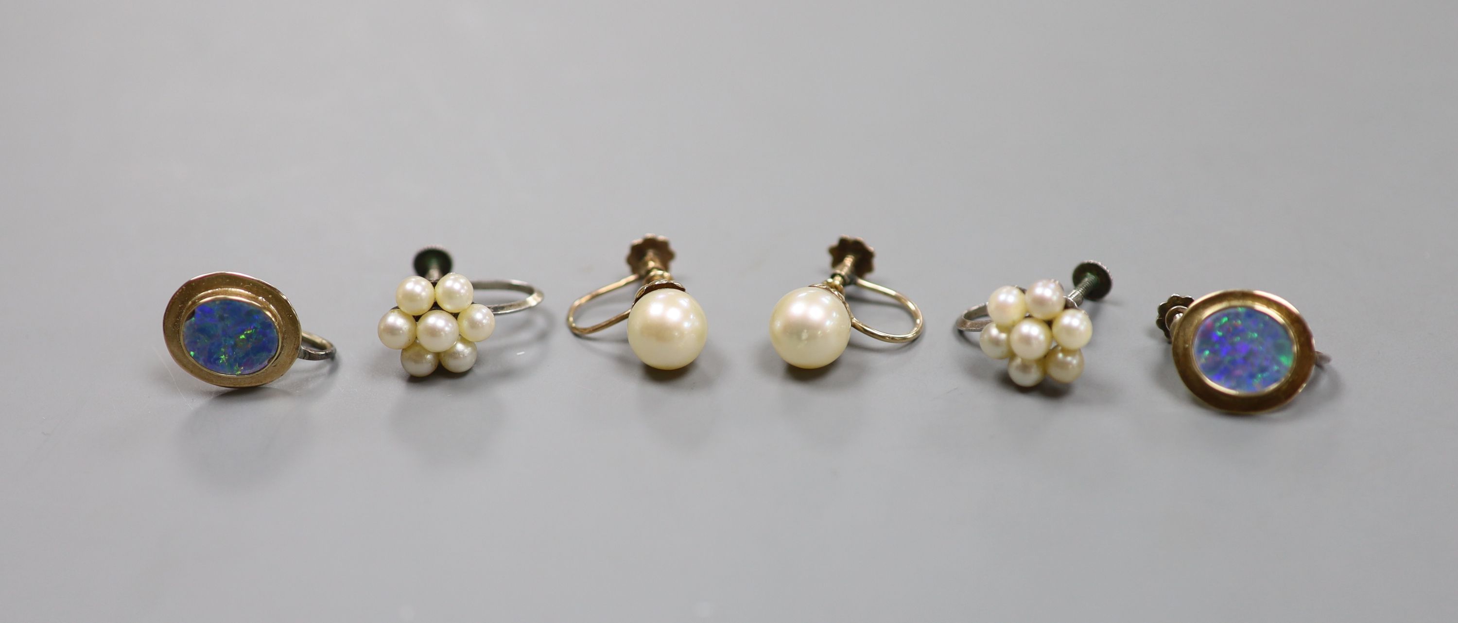 A pair of 9ct and oval black opal doublet ear clips and two pairs of cultured pearl ear clips including 9ct.